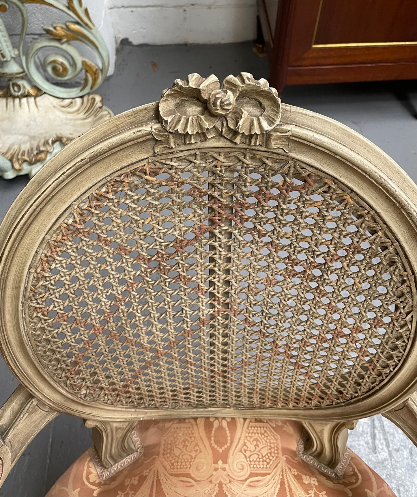 French Louis XV style cane back and upholstered seat fauteuil. With original paint and fabric is in original used condition with some stains and tears. Overall they are in good original used condition. Circa 1950's.