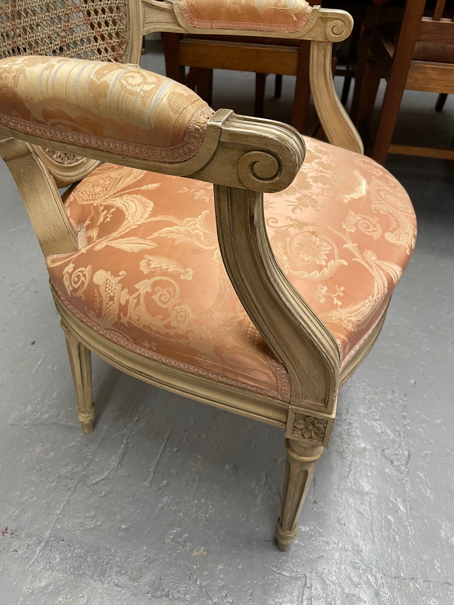 French Louis XV style cane back and upholstered seat fauteuil. With original paint and fabric is in original used condition with some stains and tears. Overall they are in good original used condition. Circa 1950's.