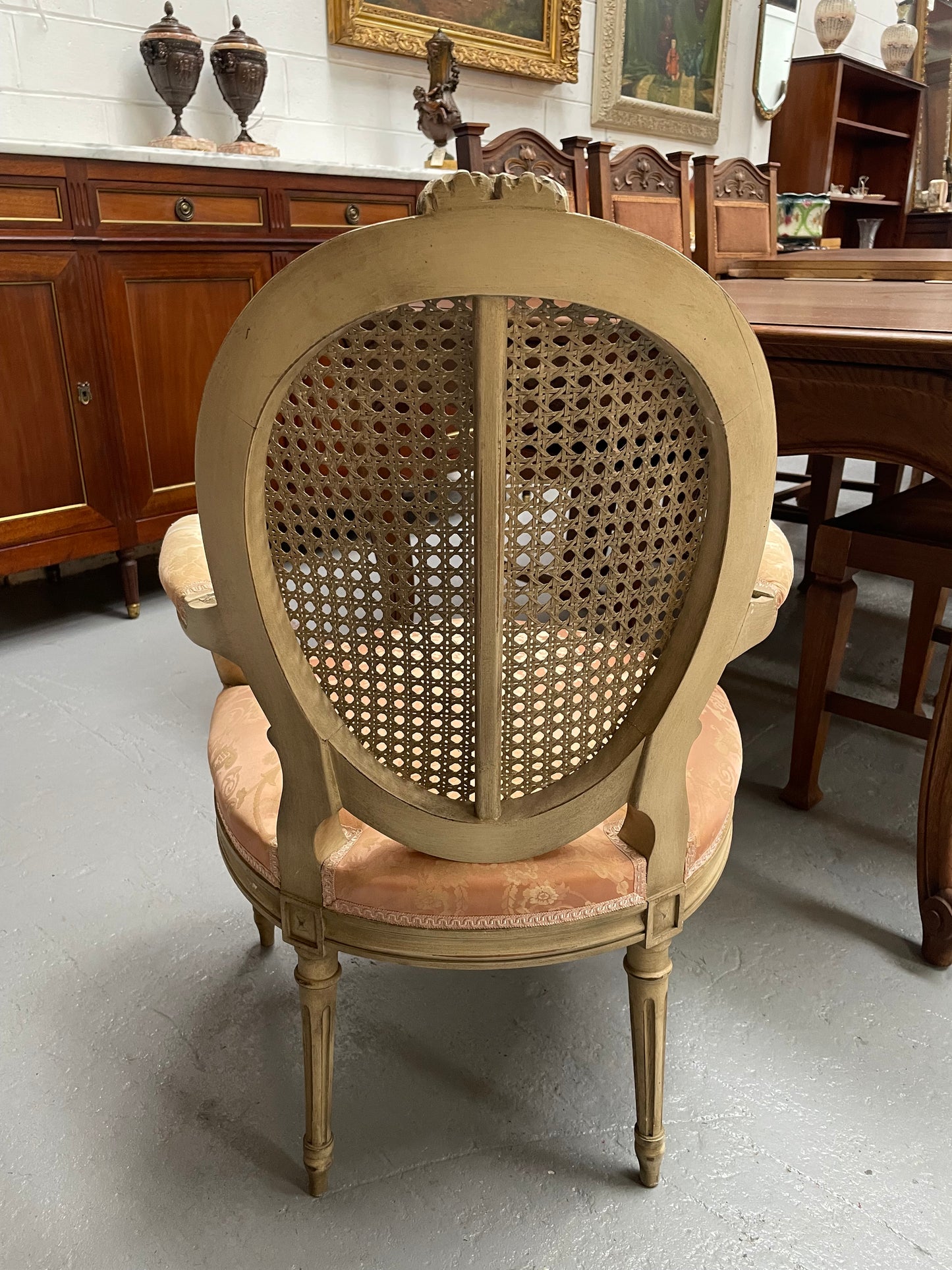 French Louis XV style cane back and upholstered seat fauteuil. With original paint and fabric is in original used condition with some stains and tears. Overall they are in good original used condition. Circa 1950's.