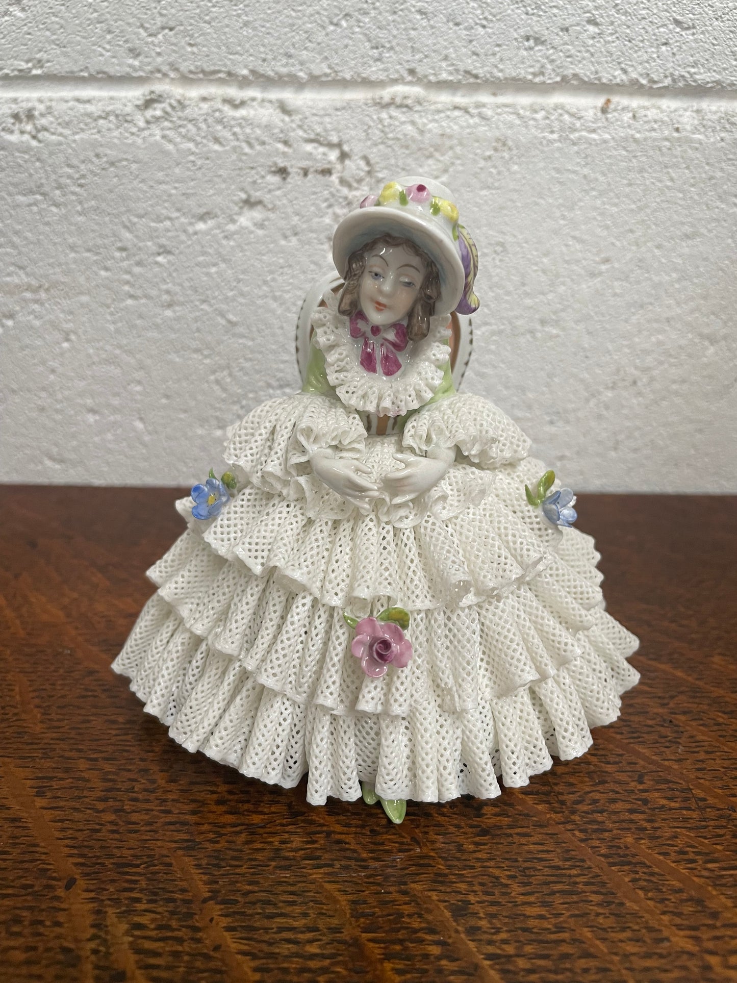 Dresden lace figurine stamped underneath and made in Germany. In good vintage condition with some slight damage to lace.