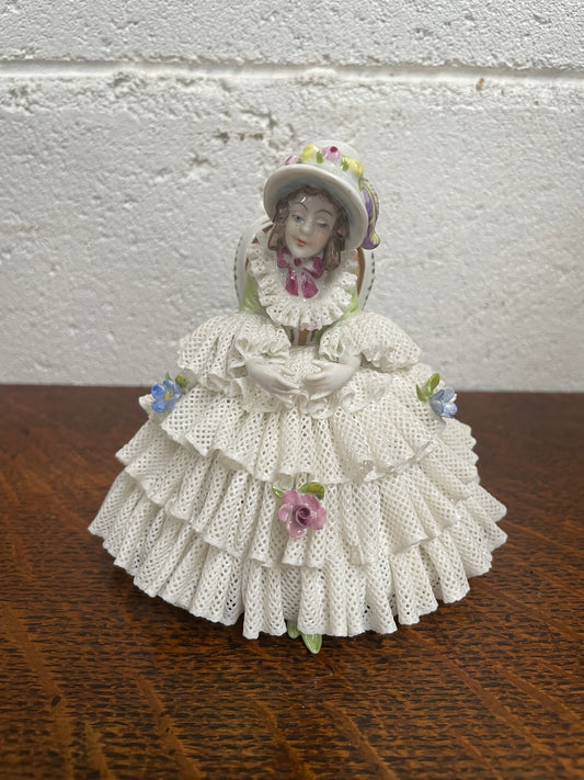 Dresden lace figurine stamped underneath and made in Germany. In good vintage condition with some slight damage to lace.