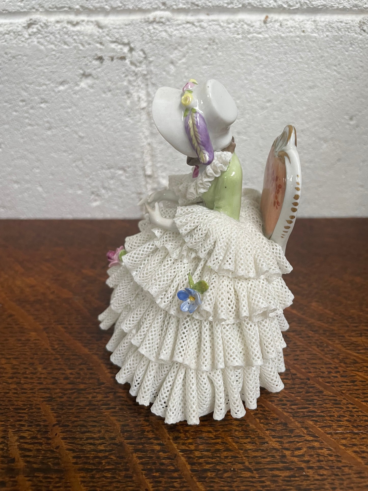 Dresden lace figurine stamped underneath and made in Germany. In good vintage condition with some slight damage to lace.