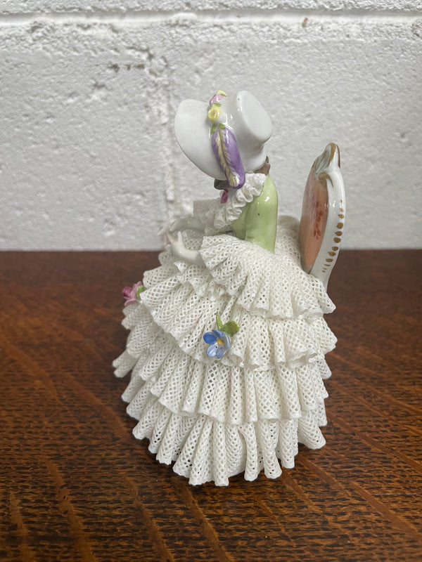 Dresden lace figurine stamped underneath and made in Germany. In good vintage condition with some slight damage to lace.