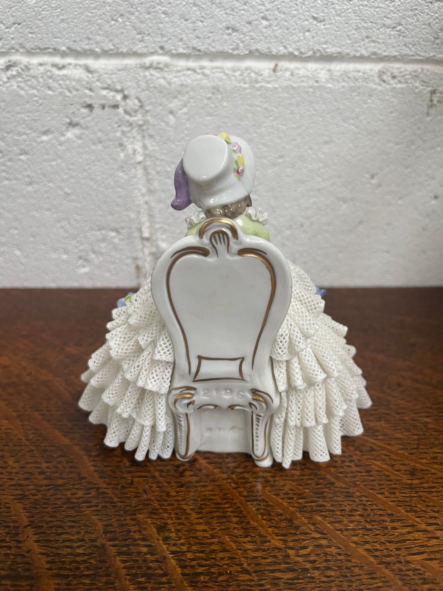 Dresden lace figurine stamped underneath and made in Germany. In good vintage condition with some slight damage to lace.