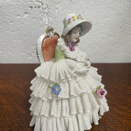 Dresden lace figurine stamped underneath and made in Germany. In good vintage condition with some slight damage to lace.
