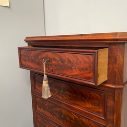 Early 19th Century Louis Phillipe style flame mahogany secretaire drawers. Presents as a seven drawer chest however three drawers are a drop down panel to a beautifully fitted secretaire/desk area. Sourced directly from France and in good original condition especially for its age. 