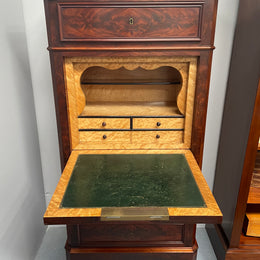 Early 19th Century Louis Phillipe style flame mahogany secretaire drawers. Presents as a seven drawer chest however three drawers are a drop down panel to a beautifully fitted secretaire/desk area. Sourced directly from France and in good original condition especially for its age. 