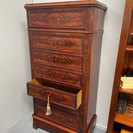 Early 19th Century Louis Phillipe style flame mahogany secretaire drawers. Presents as a seven drawer chest however three drawers are a drop down panel to a beautifully fitted secretaire/desk area. Sourced directly from France and in good original condition especially for its age. 