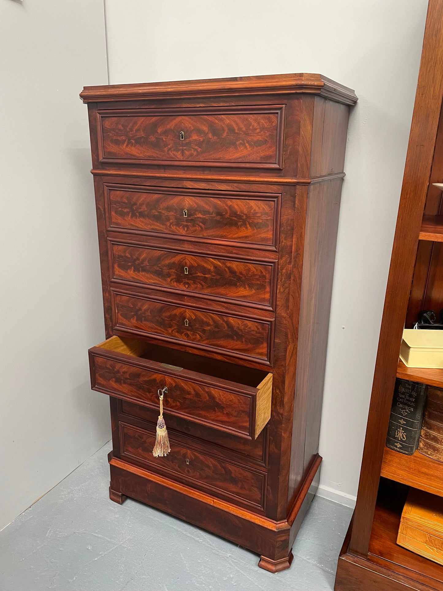 Early 19th Century Louis Phillipe style flame mahogany secretaire drawers. Presents as a seven drawer chest however three drawers are a drop down panel to a beautifully fitted secretaire/desk area. Sourced directly from France and in good original condition especially for its age. 