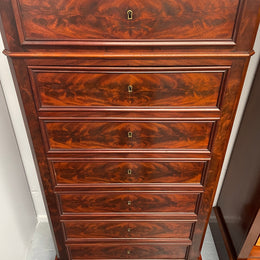 Early 19th Century Louis Phillipe style flame mahogany secretaire drawers. Presents as a seven drawer chest however three drawers are a drop down panel to a beautifully fitted secretaire/desk area. Sourced directly from France and in good original condition especially for its age. 