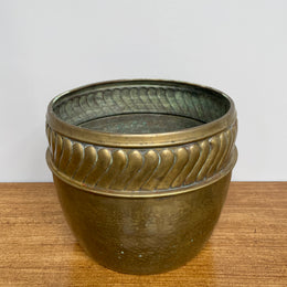 English brass decorative planter pot marked made in England on the base. In good vintage condition.