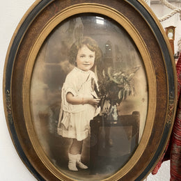 Lovely Art Deco photo frame with beautiful details on the rim and concave glass. Pretty photograph of a young girl in good original condition.