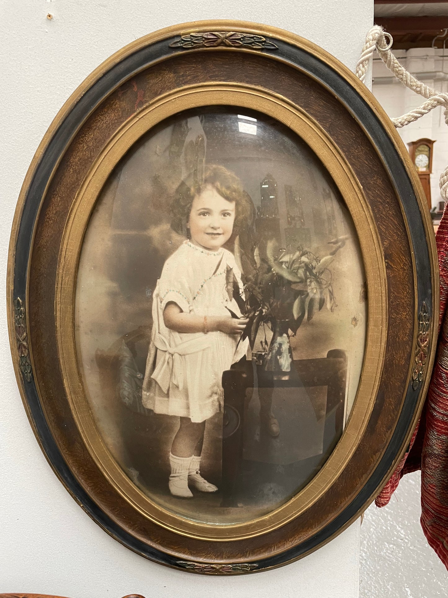 Lovely Art Deco photo frame with beautiful details on the rim and concave glass. Pretty photograph of a young girl in good original condition.