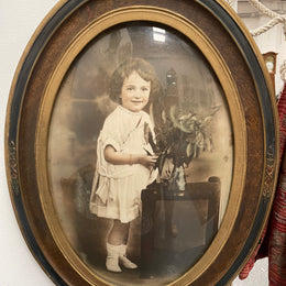 Lovely Art Deco photo frame with beautiful details on the rim and concave glass. Pretty photograph of a young girl in good original condition.