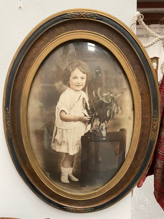 Lovely Art Deco photo frame with beautiful details on the rim and concave glass. Pretty photograph of a young girl in good original condition.