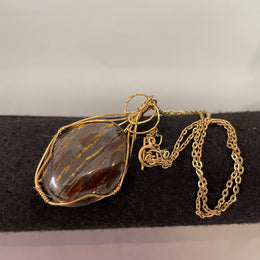 An Attractive Chocolate Calcite Pendant In a Gold Plated Setting