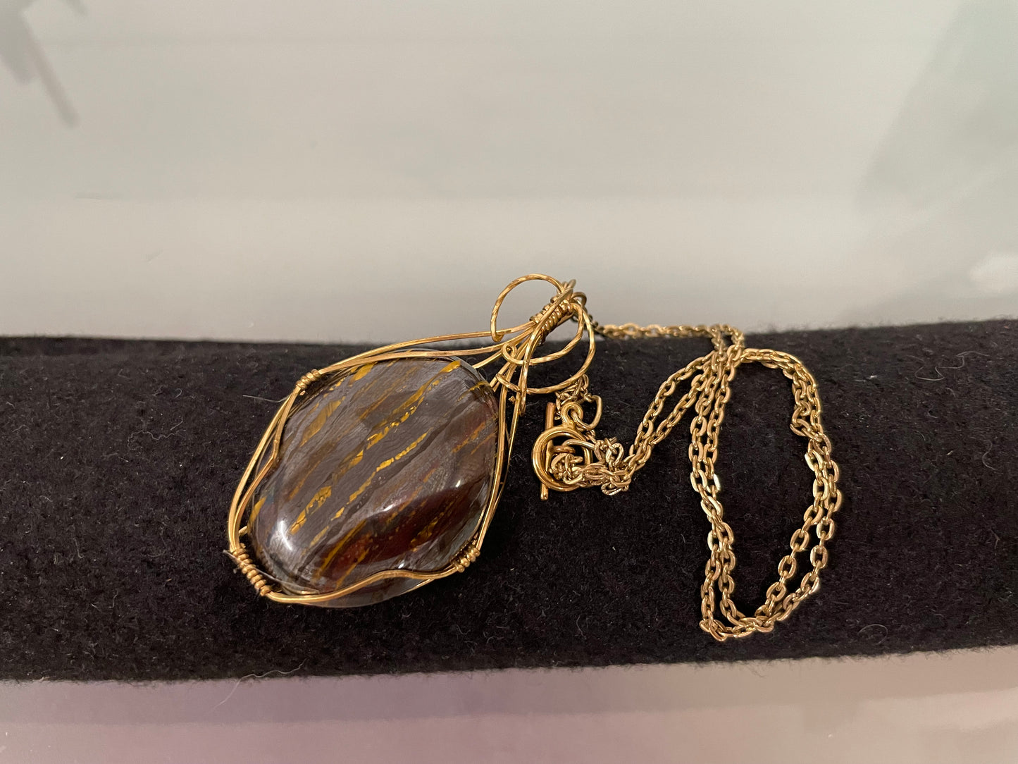 An Attractive Chocolate Calcite Pendant In a Gold Plated Setting