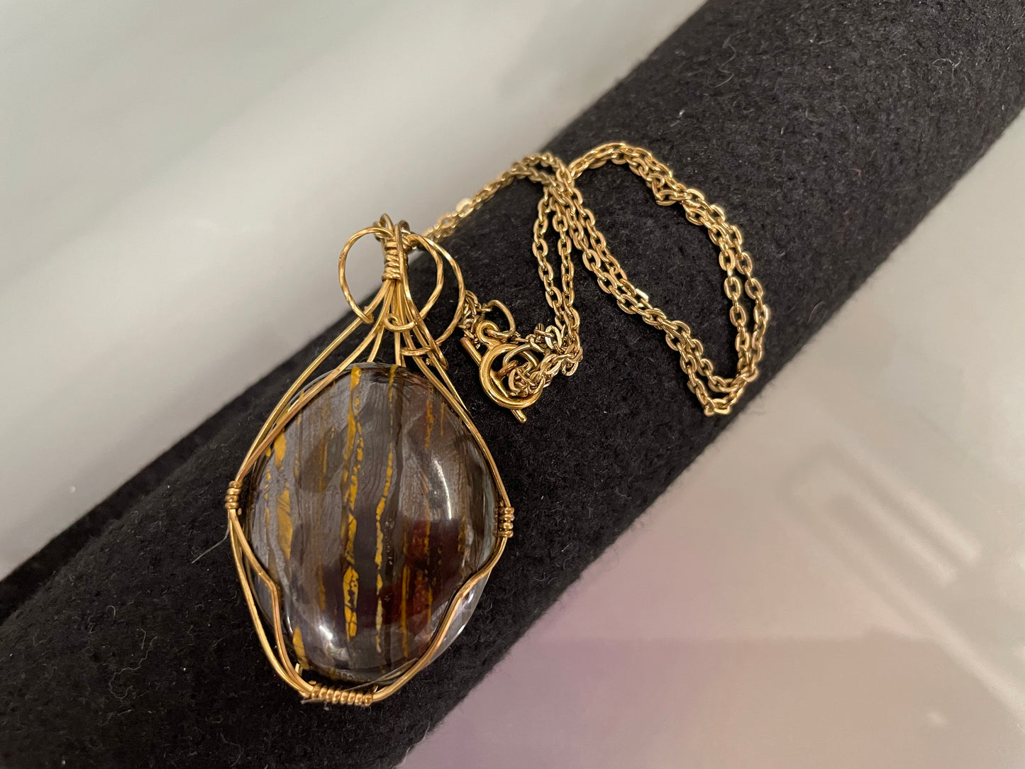 An Attractive Chocolate Calcite Pendant In a Gold Plated Setting