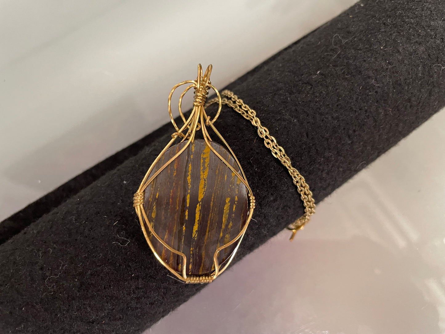 An Attractive Chocolate Calcite Pendant In a Gold Plated Setting