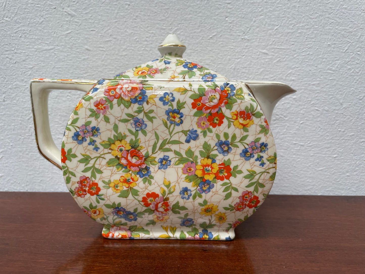 Empire made in England teapot With floral pattern. Marked underneath and is in good original used condition with no chips. Please view photos as they help form part of the description.