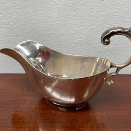 Marked hand soldered vintage gravy boat made in England. It has a lovely handle and is in good original condition. Please see photos as they form part of the description.