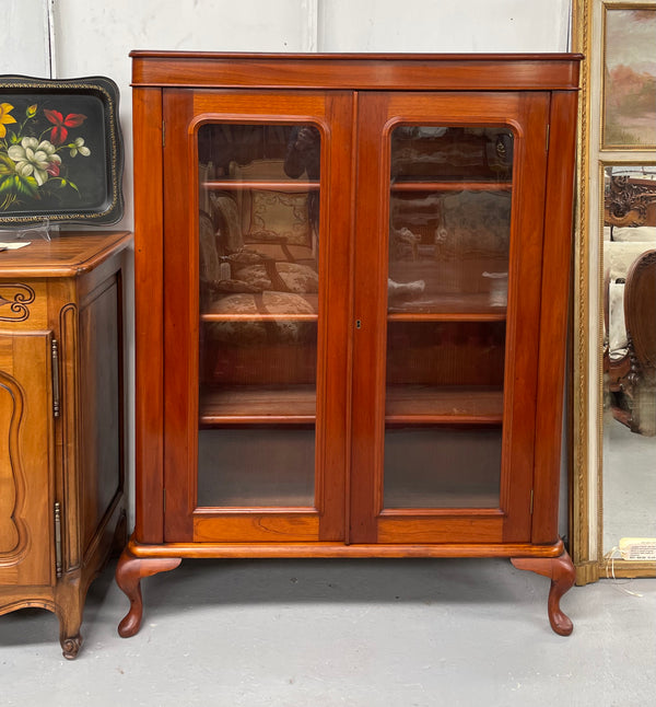 Practical late Victorian Cedar two door bookcase on cabriole feet and adjustable shelves. In good condition. Please see photos as they form part of the description. Circa: 1890's