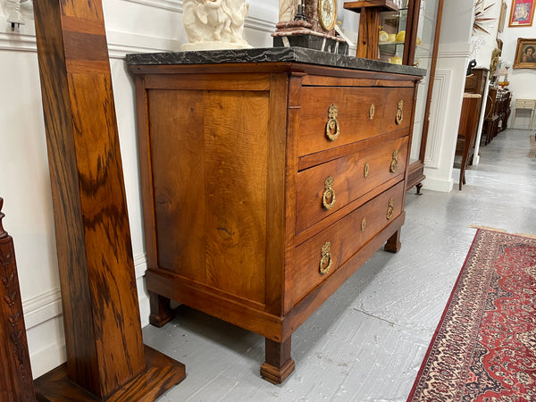 Magnificent early 19th Century French Walnut Empire three drawer commode with a stunning black/grey marble top and beautifully decorated handles. It has been sourced directly from France and is in good original condition. 