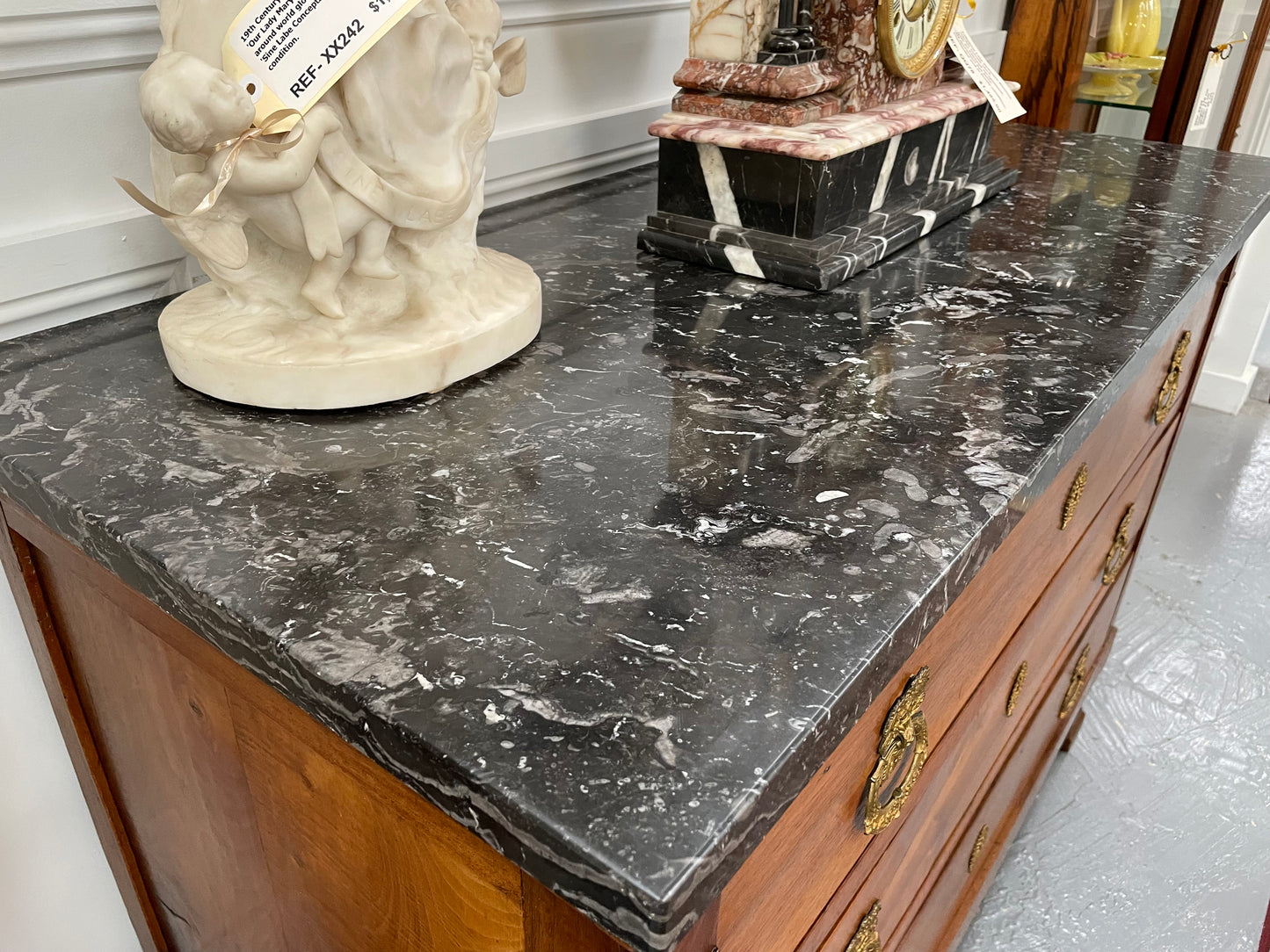 Magnificent early 19th Century French Walnut Empire three drawer commode with a stunning black/grey marble top and beautifully decorated handles. It has been sourced directly from France and is in good original condition. 