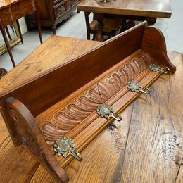 French oak wall coat rack with four decorative hooks and shelf. It has been sourced from France and is in good original condition. 