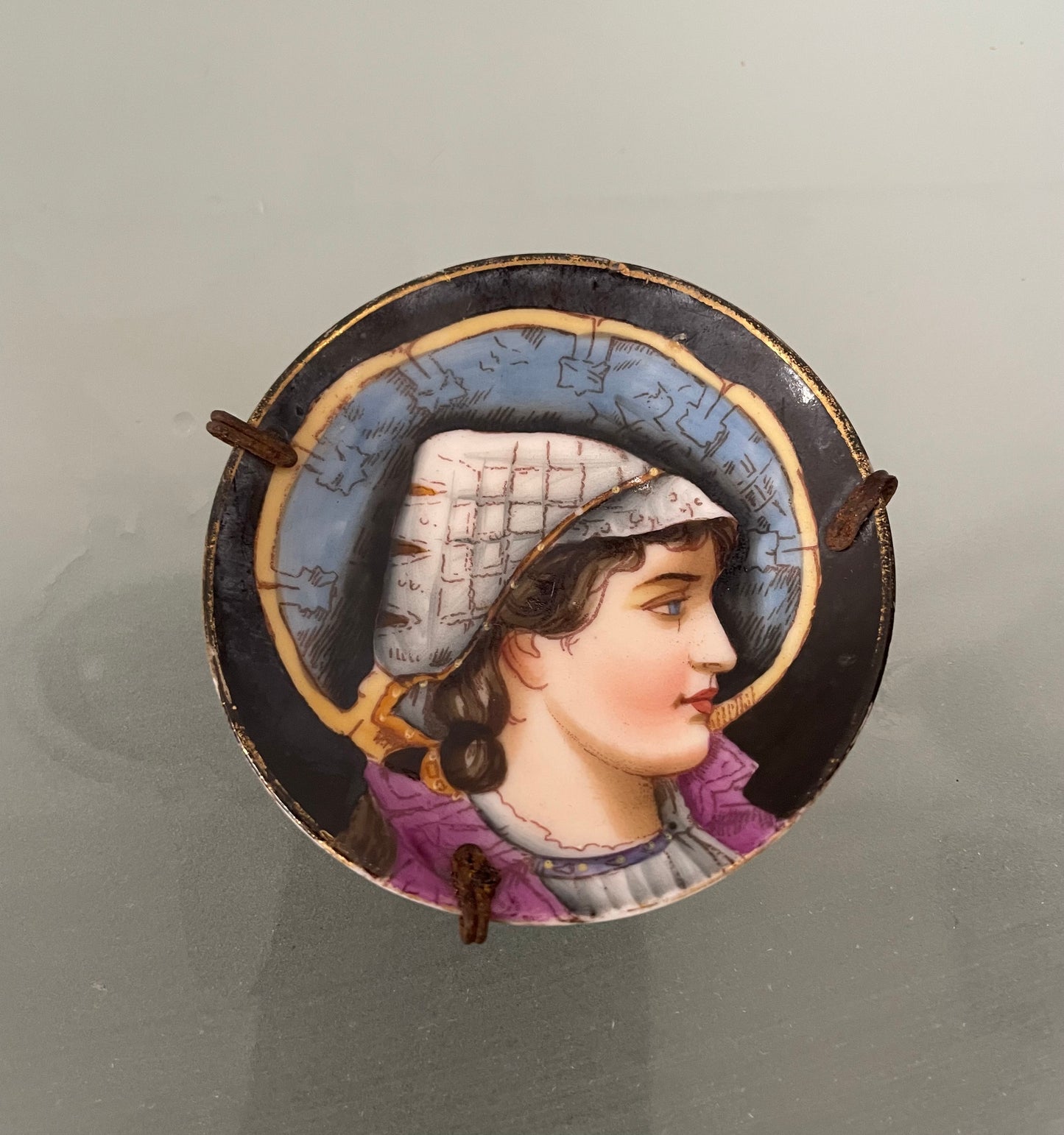Antique miniature hand painted dish of a woman in profile. In good original condition.  Please see photos as they form part of the description.