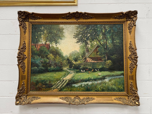 Fabulous large French oil on canvas depicting a country house with chickens around the garden. It is framed in a lovely ornate gold frame and in good original condition. 