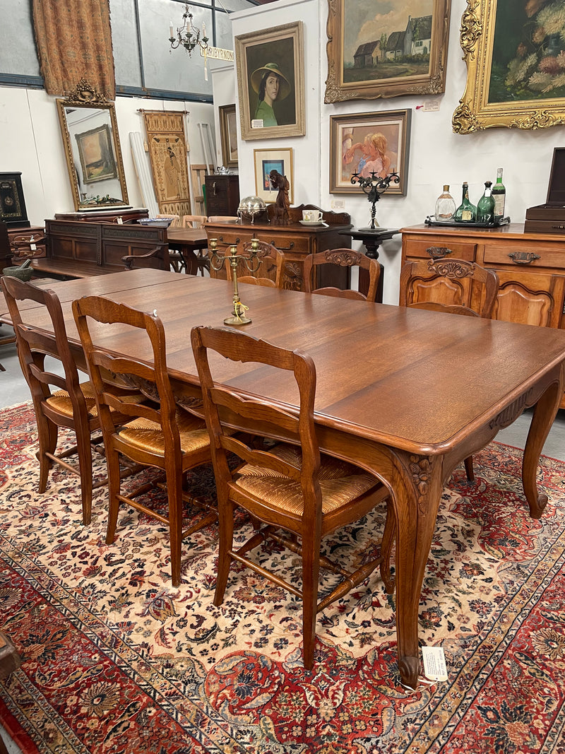 Lovely set of six French rush seat dining chairs. They feature decorative carved detailing particularly to the top of the chair. They are in good original detailed condition and have been sourced from France. 