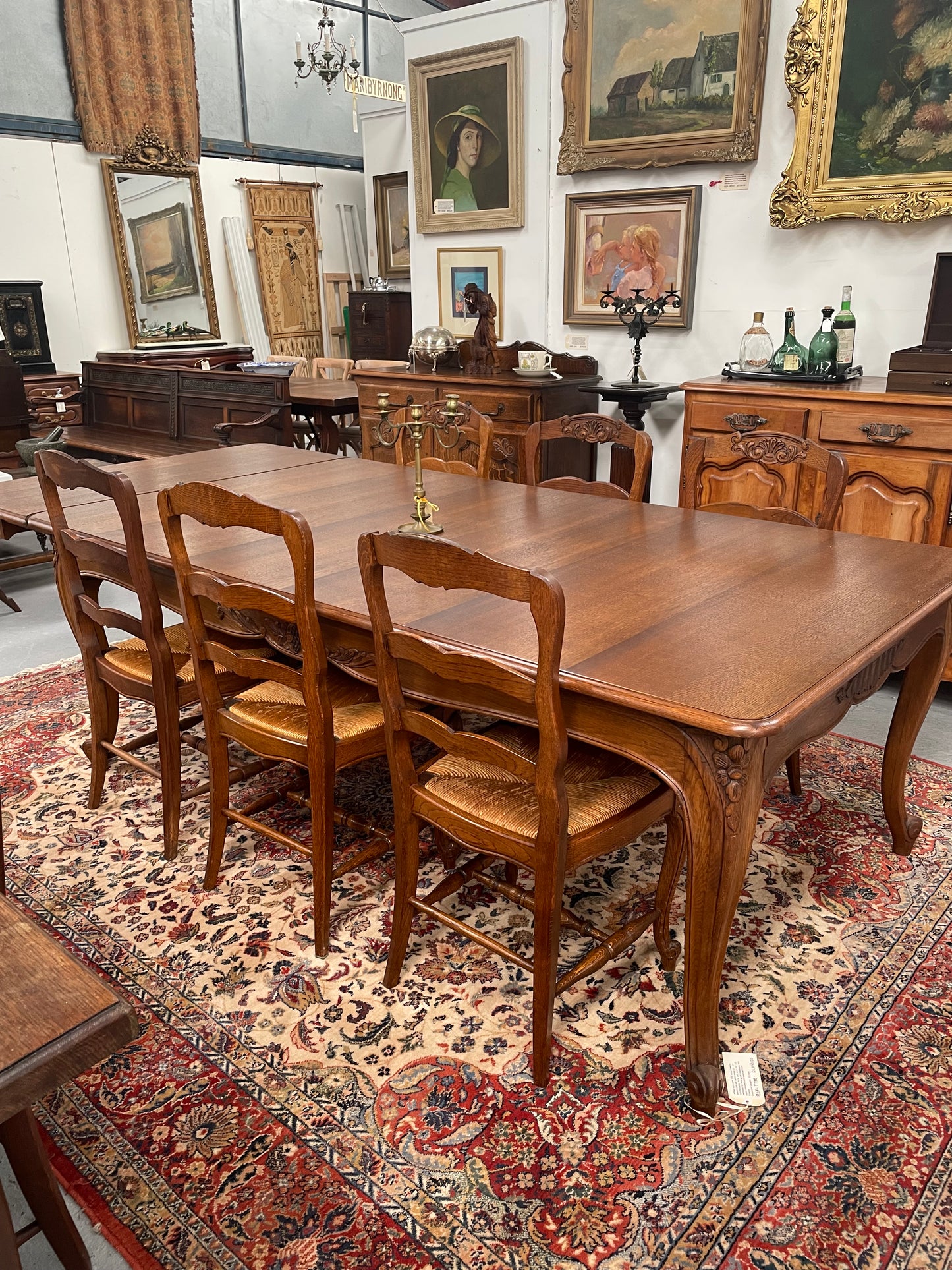 Lovely set of six French rush seat dining chairs. They feature decorative carved detailing particularly to the top of the chair. They are in good original detailed condition and have been sourced from France. 