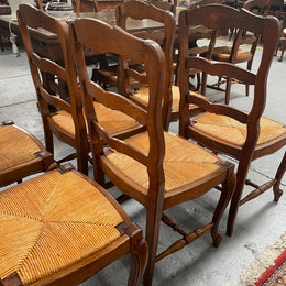 Lovely set of six French rush seat dining chairs. They feature decorative carved detailing particularly to the top of the chair. They are in good original detailed condition and have been sourced from France. 