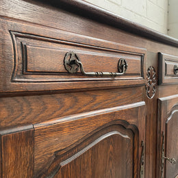Charming French Oak provincial two door buffet. It has two drawers and a cupboard with two doors and one shelf. It is in good original condition and has been sourced directly from France.