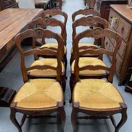 Set of six French Oak Louis XV style rush seat dining chairs . Nicely carved details and they have been sourced directly from France. They are in good original detailed condition.