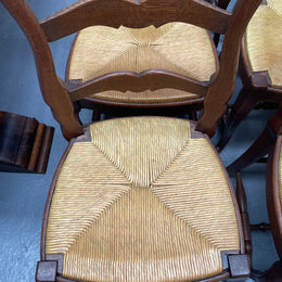 Set of six French Oak Louis XV style rush seat dining chairs . Nicely carved details and they have been sourced directly from France. They are in good original detailed condition.