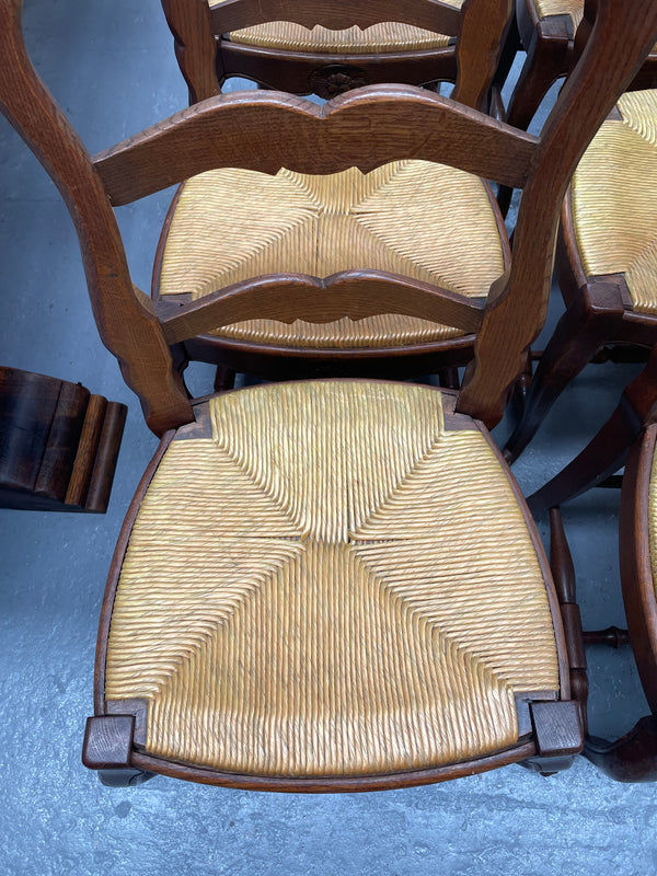 Set of six French Oak Louis XV style rush seat dining chairs . Nicely carved details and they have been sourced directly from France. They are in good original detailed condition.