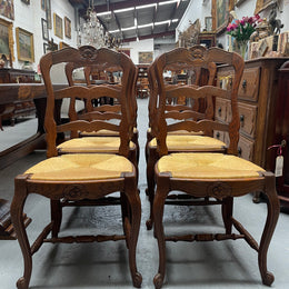 Set of six French Oak Louis XV style rush seat dining chairs . Nicely carved details and they have been sourced directly from France. They are in good original detailed condition.