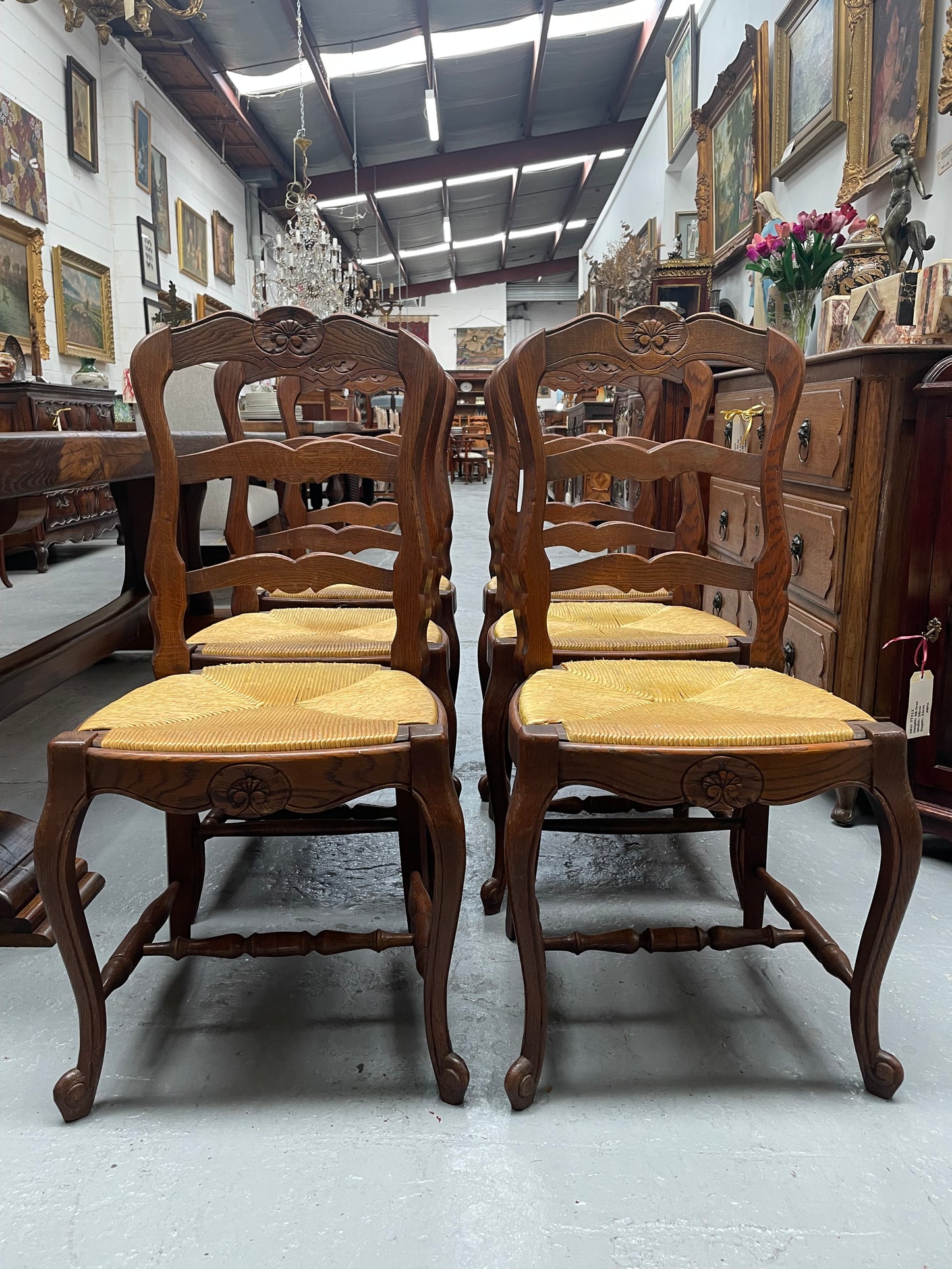 Set of six French Oak Louis XV style rush seat dining chairs . Nicely carved details and they have been sourced directly from France. They are in good original detailed condition.