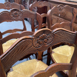 Set of six French Oak Louis XV style rush seat dining chairs . Nicely carved details and they have been sourced directly from France. They are in good original detailed condition.