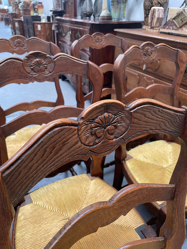 Set of six French Oak Louis XV style rush seat dining chairs . Nicely carved details and they have been sourced directly from France. They are in good original detailed condition.