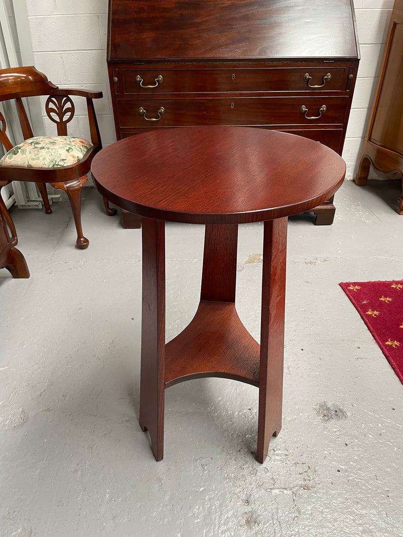 Practical round Arts and Crafts side table stained in a mahogany colour. Sourced locally and in good original condition. Please see all photos as they form part of the description and condition.