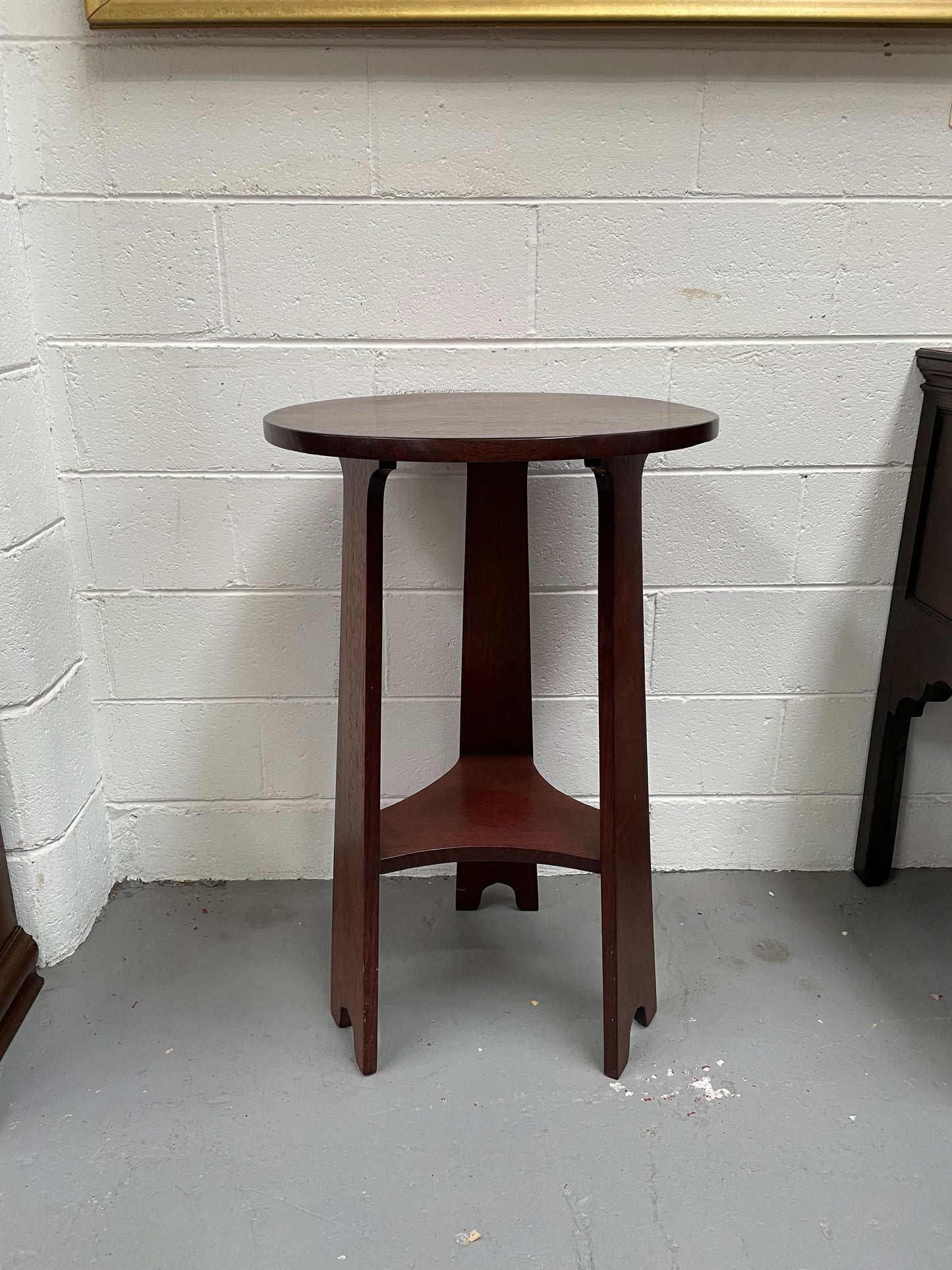 Practical round Arts and Crafts side table stained in a mahogany colour. Sourced locally and in good original condition. Please see all photos as they form part of the description and condition.