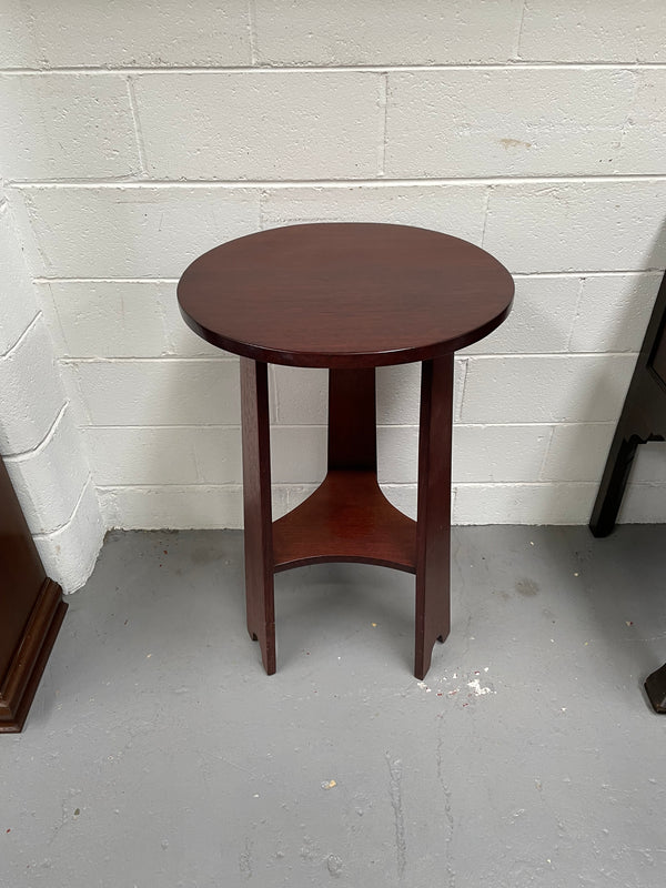 Practical round Arts and Crafts side table stained in a mahogany colour. Sourced locally and in good original condition. Please see all photos as they form part of the description and condition.