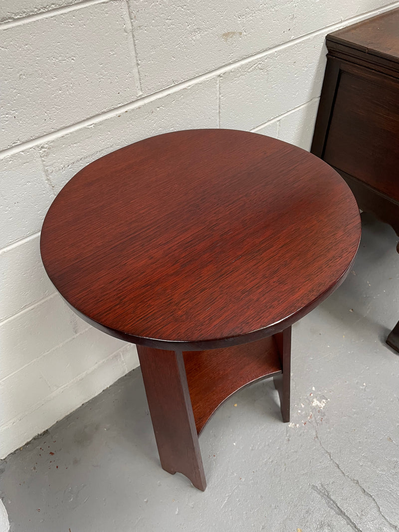 Practical round Arts and Crafts side table stained in a mahogany colour. Sourced locally and in good original condition. Please see all photos as they form part of the description and condition.