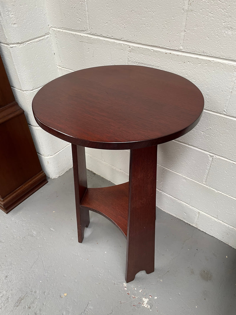 Practical round Arts and Crafts side table stained in a mahogany colour. Sourced locally and in good original condition. Please see all photos as they form part of the description and condition.