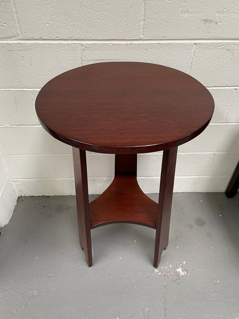 Practical round Arts and Crafts side table stained in a mahogany colour. Sourced locally and in good original condition. Please see all photos as they form part of the description and condition.