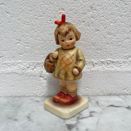 Beautiful Hummel Figurine "I Bought You a Gift", of a girl with her basket. In good original condition. Please see photos as they form part of the description.