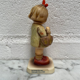 Beautiful Hummel Figurine "I Bought You a Gift", of a girl with her basket. In good original condition. Please see photos as they form part of the description.